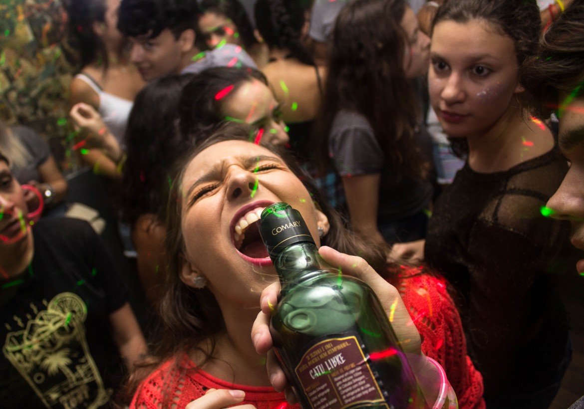 woman-wearing-red-shirt-drinking-948199